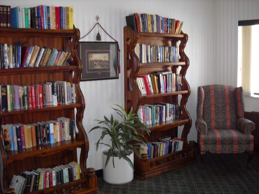 Interior library with bookshelves and a reading chair