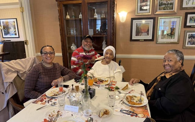 Residents enjoying a meal together in the dining room