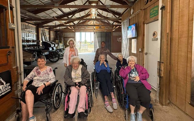 Residents in wheelchairs enjoying a social moment indoors