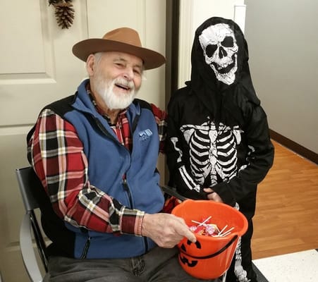 An elderly man and a child in Halloween costumes