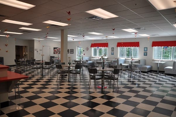 Spacious dining area with checkered floor and seating
