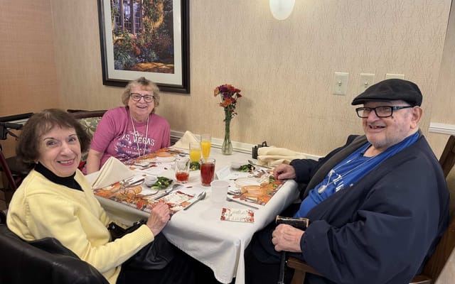 Residents enjoying a meal together in the dining area