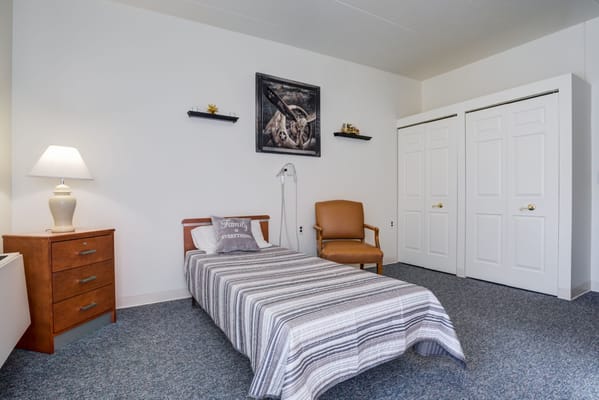 Private room with a bed and furniture