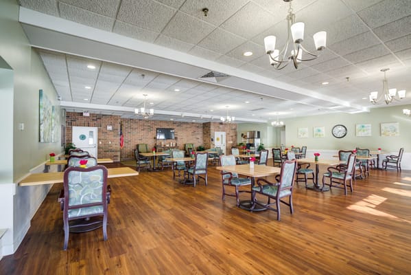 Bright dining room with wooden floors and seating