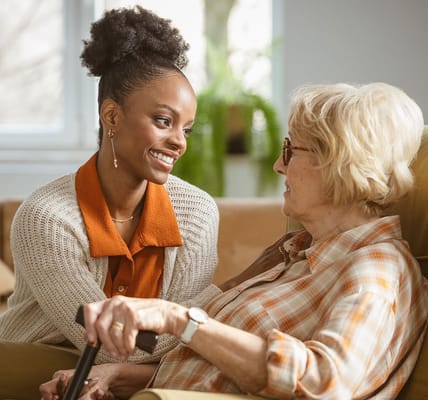 Staff member interacting with a resident in a cozy setting