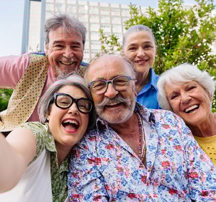 Happy residents posing for a selfie outdoors