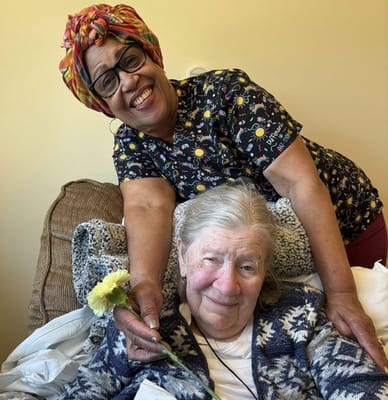 Staff member posing happily with a resident