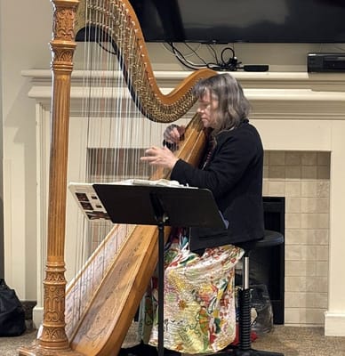 Resident playing harp in a common area
