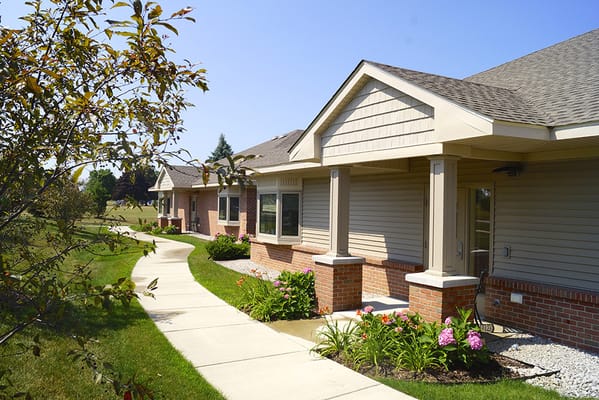 Pathway leading to the facility with landscaped gardens