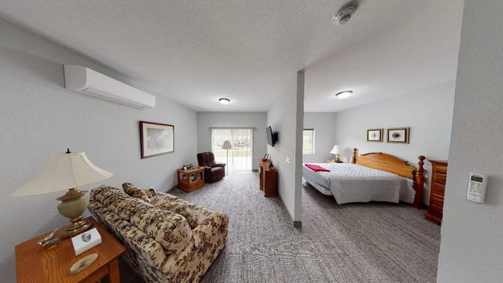 Cozy resident room with a bed and seating area