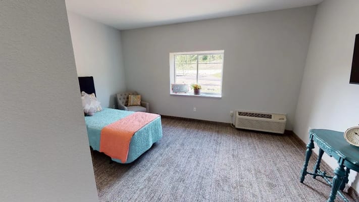 Private resident room with a bed and window