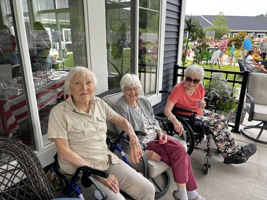 Three residents enjoying the outdoors in wheelchairs