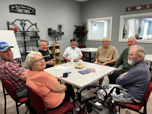 Residents engaged in a group discussion around a table