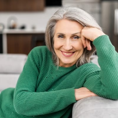 Senior woman smiling in a cozy living area