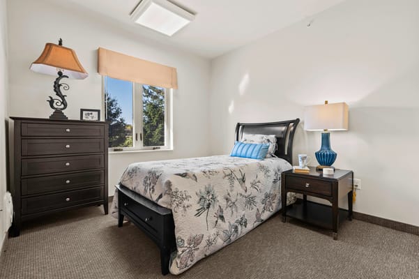 Cozy bedroom interior with a floral bedspread
