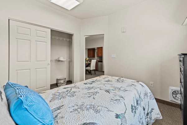 Private room with a bed and closet in a senior care facility