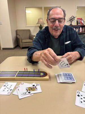 Resident playing cards in a common area