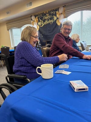 Residents enjoying a card game in a common area