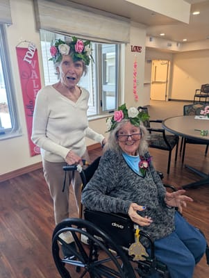 Two residents in festive headbands during an activity