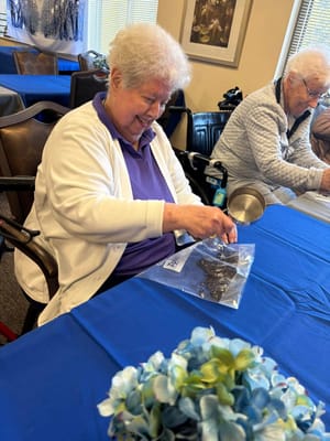 Resident engaging in an activity at a communal table