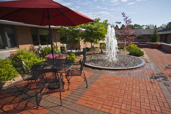 Outdoor patio with fountain and seating area