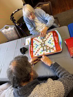 Residents playing a board game in a common area