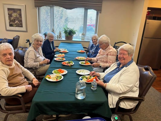 Residents enjoying a meal together in the dining room