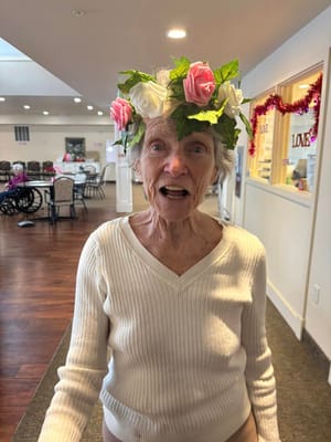 Resident wearing a floral crown in a common area
