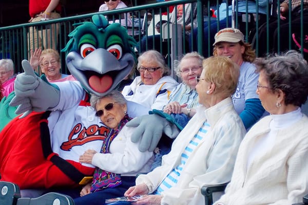 Residents enjoying a day at a baseball game with mascot