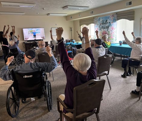 Residents participating in an exercise class in an activity room