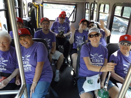 Residents and staff enjoying a bus ride together