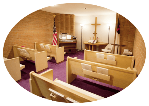 Interior view of a chapel with wooden pews