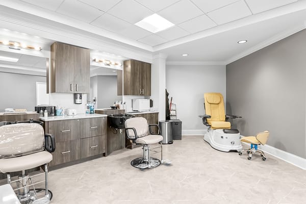 Interior view of a beauty salon area with chairs and equipment