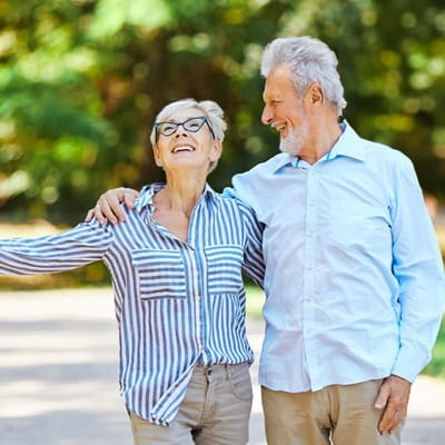 Seniors enjoying a walk together in a park