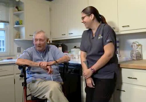 Staff member engaging with a resident in the kitchen