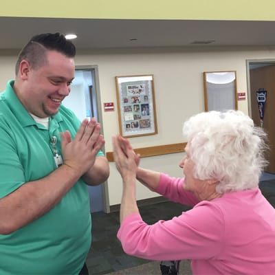 Staff member engaging in an activity with a resident