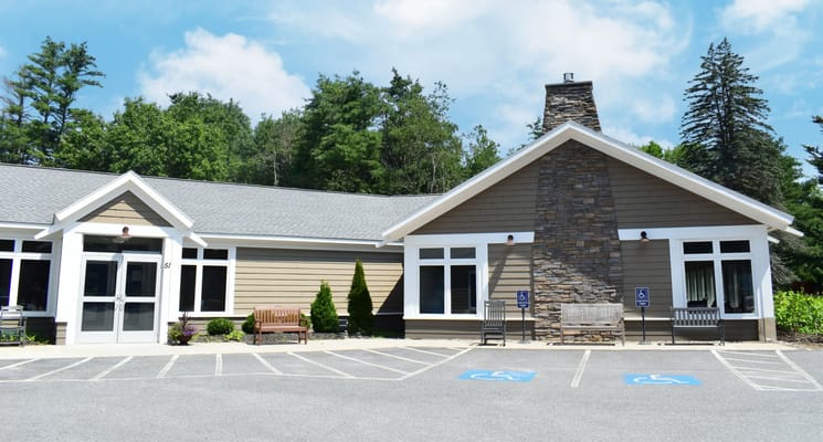 Exterior view of a senior living facility with accessible parking