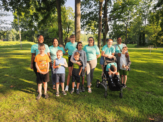 Group of residents and staff in an outdoor setting