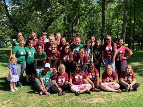 Staff group photo outdoors at a facility event