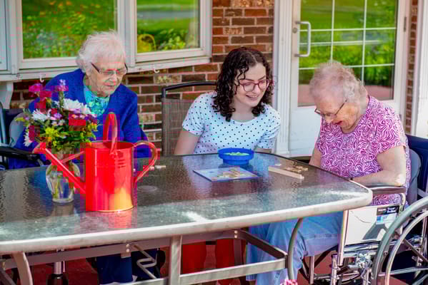 Residents enjoying an activity outdoors with staff