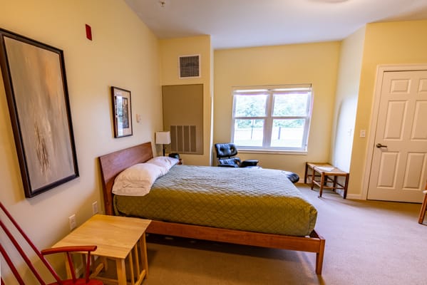 Cozy resident room with a bed and seating area