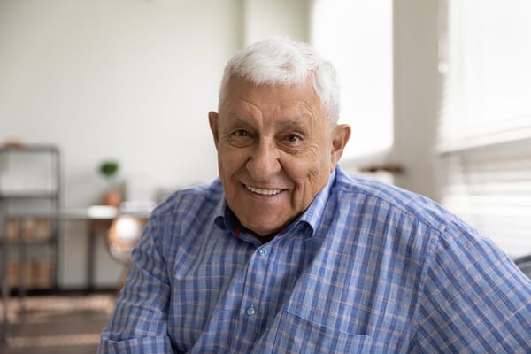 Smiling older man in a modern interior space