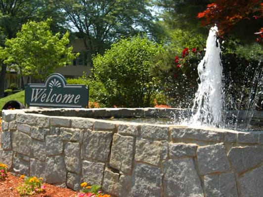 Welcoming landscaped area with a fountain