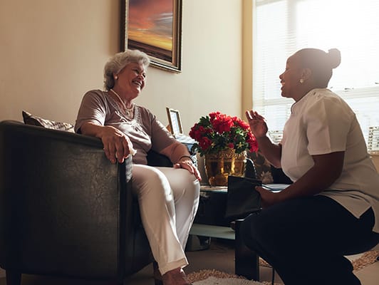 Staff member engaging with a resident in a comfortable setting