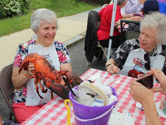 Residents enjoying a lobster feast at an outdoor event