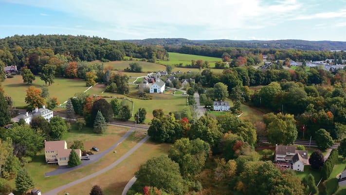 Aerial view of a senior living campus surrounded by trees