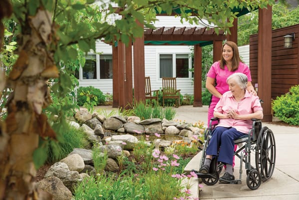 Resident enjoying outdoor space with caregiver
