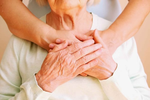 Close-up of elderly hands with nurturing embrace