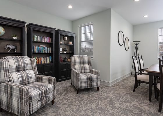 Bright common area with comfortable seating and bookshelves