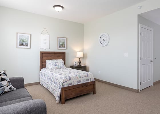 Bright private room with a bed and seating area